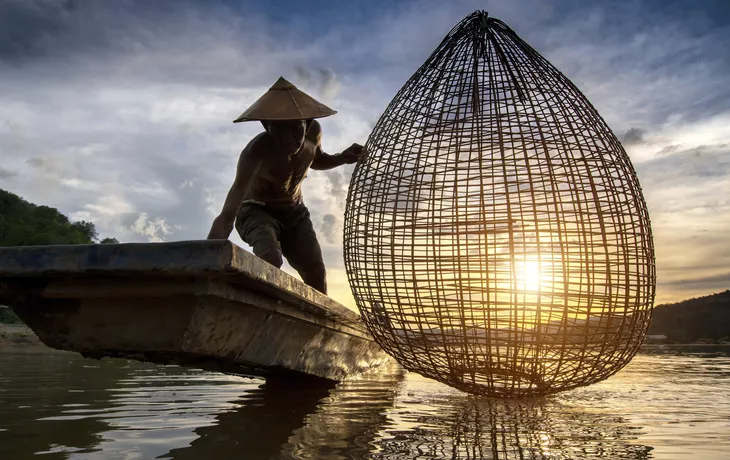 © sirisakboakaew - stock.adobe.com - Fischer auf dem Mekong